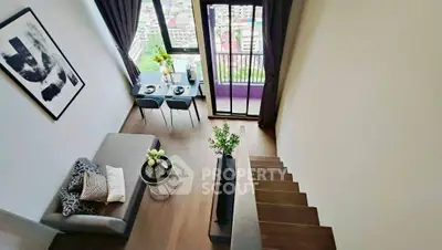 Modern loft apartment with stylish decor and city view from balcony.