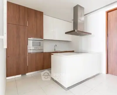 Modern kitchen with sleek cabinetry and built-in appliances in a stylish apartment.