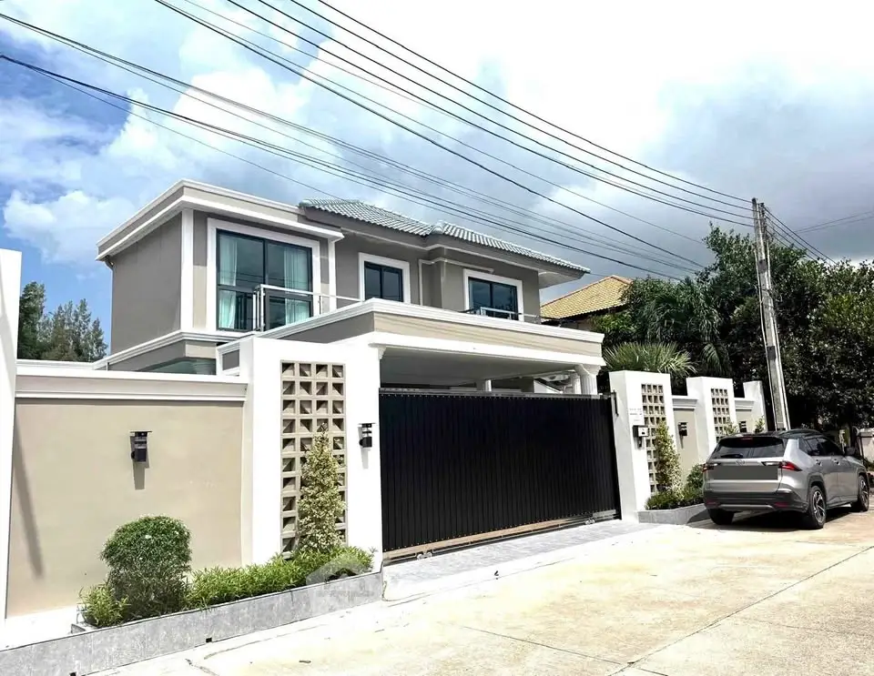 Stunning modern two-story house with sleek design and spacious driveway in a serene neighborhood.