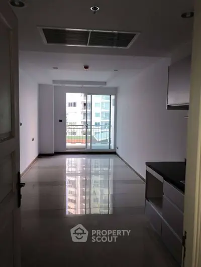 Modern apartment with sleek kitchen and balcony view