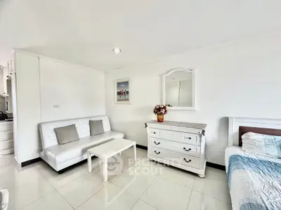 Charming living room with elegant white furniture and cozy decor, perfect for relaxation and comfort.