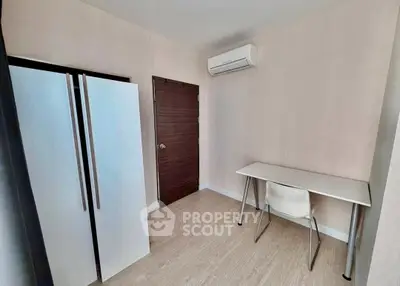 Minimalist study room with desk, chair, and air conditioning