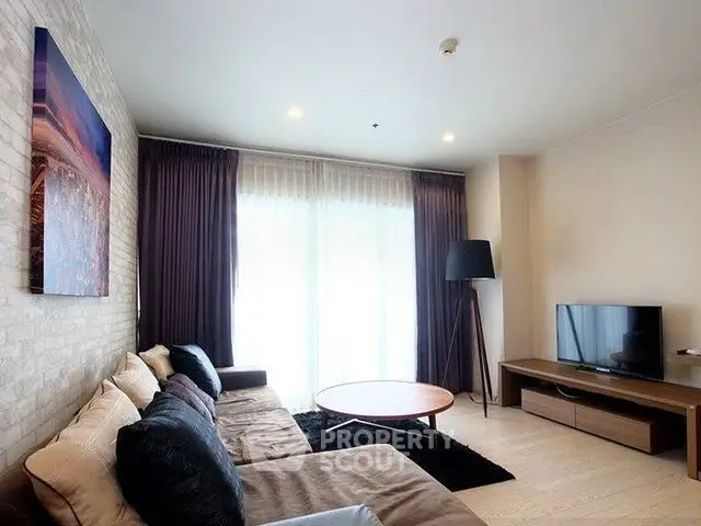 Modern living room with cozy sectional sofa and large window for natural light.