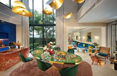 Luxurious open-plan living room with elegant decor and garden view.