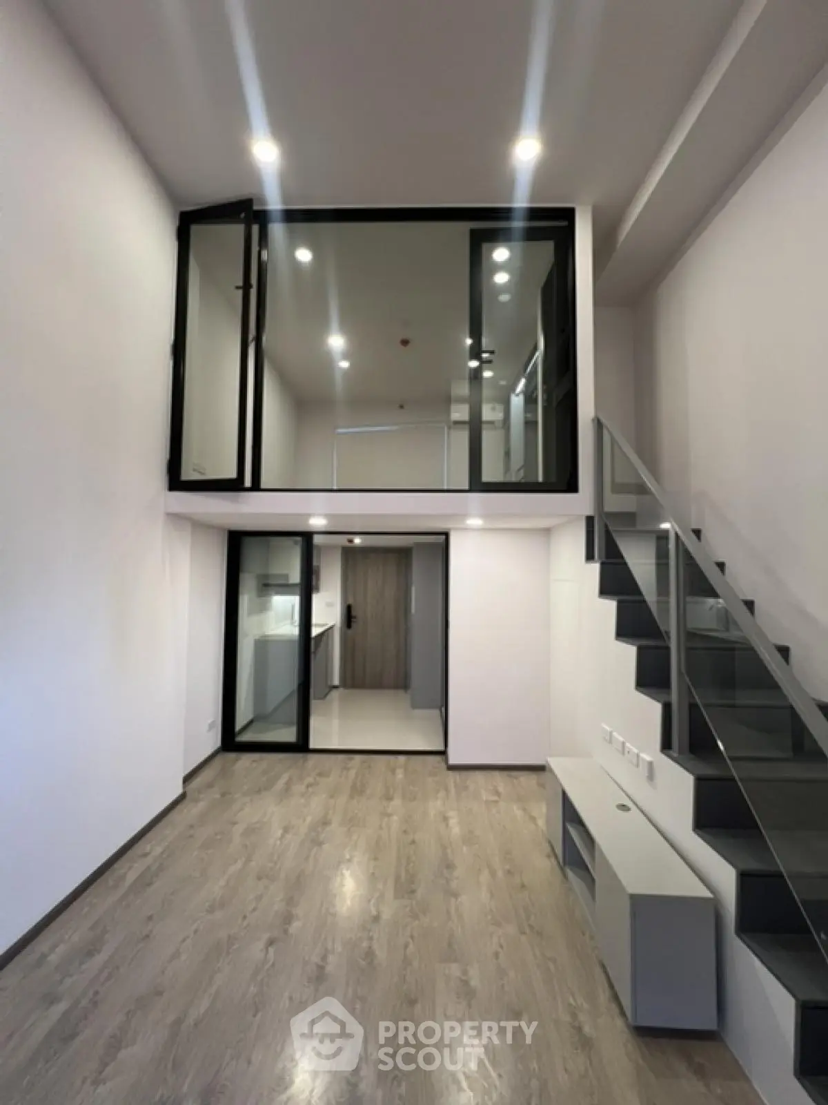 Modern duplex apartment with sleek staircase and open layout