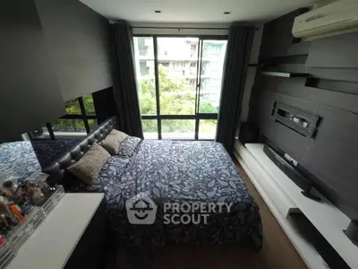 Modern bedroom with large window and stylish decor in urban apartment