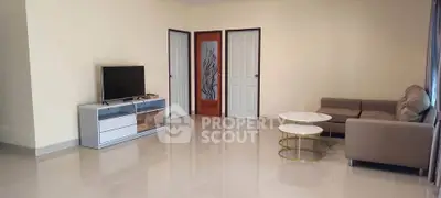 Spacious living room with modern furniture and TV unit, perfect for relaxation and entertainment.