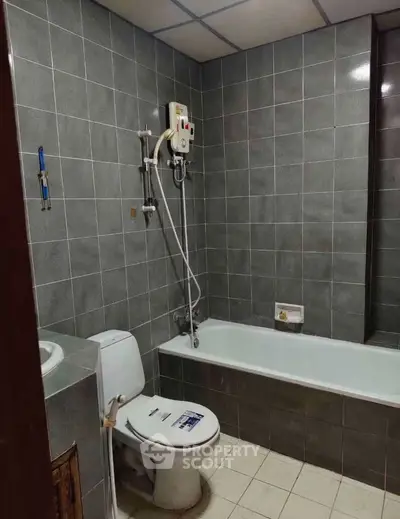 Modern bathroom with bathtub and shower in a tiled setting