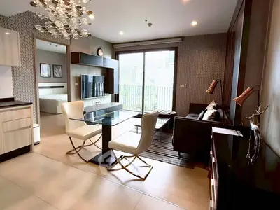 Modern open-plan living room with stylish decor and balcony view