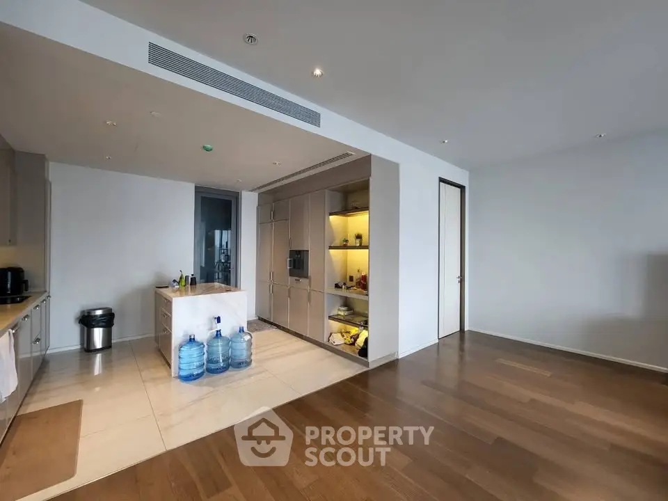 Spacious modern kitchen with sleek cabinetry and wooden flooring