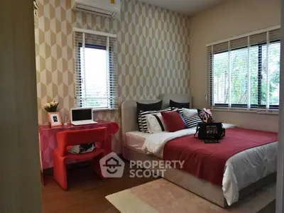 Chic bedroom with modern decor and stylish workspace, perfect for comfort and productivity.