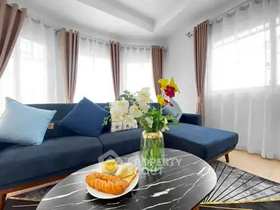 Elegant living room with stylish sofa and decorative accents, perfect for modern living.