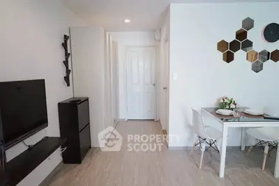 Modern living room with stylish decor and dining area in a contemporary apartment.