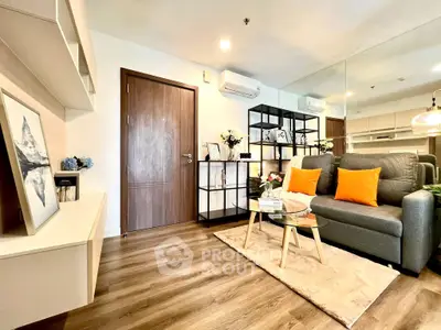 Modern living room with stylish decor, wooden flooring, and cozy seating area.