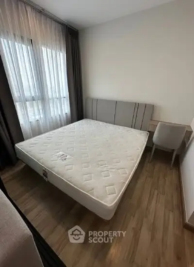 Modern bedroom with large window and stylish furniture