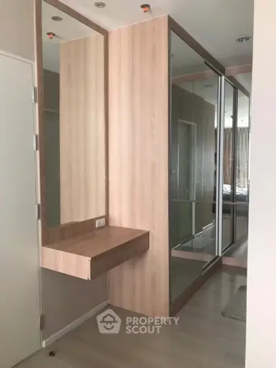 Modern bedroom with mirrored wardrobe and wooden vanity