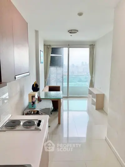 Modern apartment with open kitchen and city view from balcony