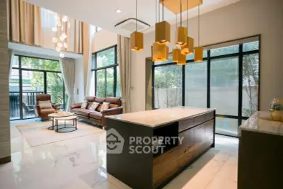 Luxurious open-plan living room with modern kitchen and elegant lighting