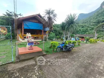 Charming rustic house with lush garden and mountain backdrop, perfect for nature lovers seeking tranquility.