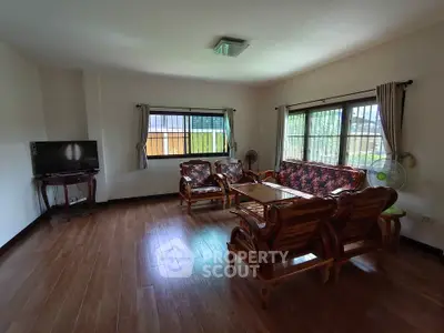 Spacious living room with wooden flooring and elegant furniture