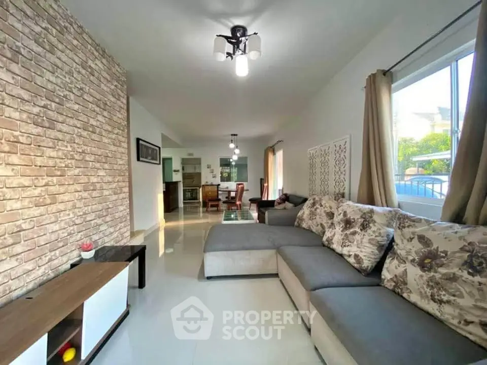 Spacious living room with modern decor and large windows for natural light.