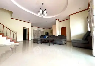 Spacious living room with modern furniture and elegant ceiling design