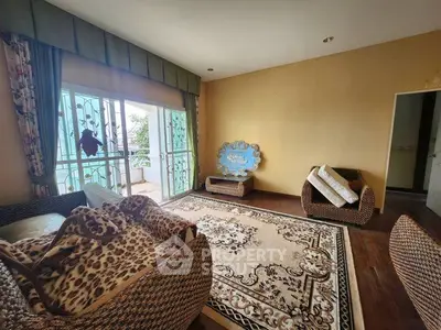 Spacious living room with elegant decor and balcony access
