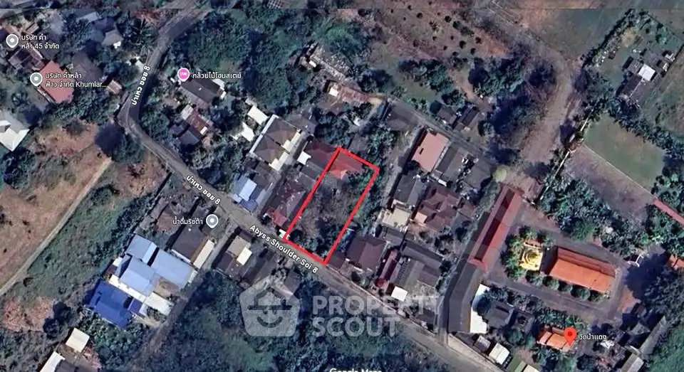 Aerial view of residential area with marked property boundary in vibrant neighborhood.