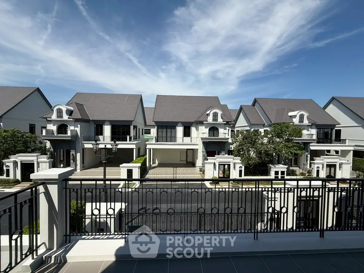 Luxurious residential neighborhood with elegant houses and clear blue sky.
