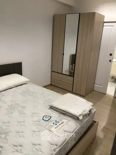 Cozy bedroom with modern wardrobe and comfortable bed in a stylish apartment.
