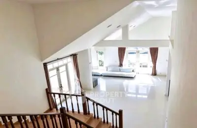 Spacious modern living room with high ceilings and large windows for natural light.
