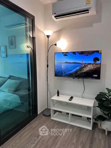 Modern living room with sleek TV setup and stylish decor, featuring a cozy ambiance and contemporary design.