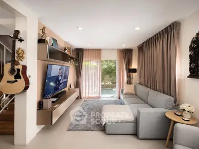 Stylish living room with modern decor, cozy sofa, and large TV, perfect for relaxation and entertainment.