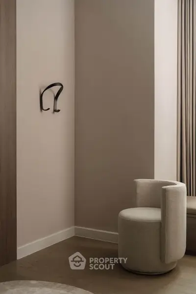 Elegant modern interior with stylish chair and minimalist decor in a serene corner setting.