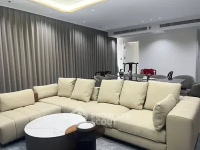 Luxurious modern living room with plush beige sofa and elegant decor.