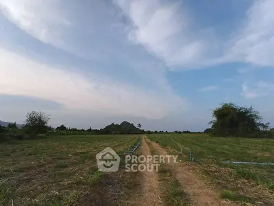 Expansive land plot with clear skies, ideal for development or agriculture.