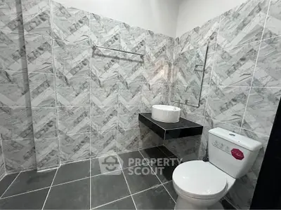 Modern bathroom with stylish tile design and sleek fixtures