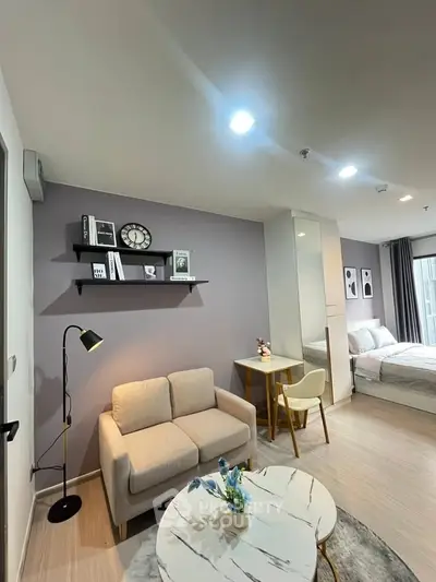 Modern studio apartment with cozy living area and stylish decor