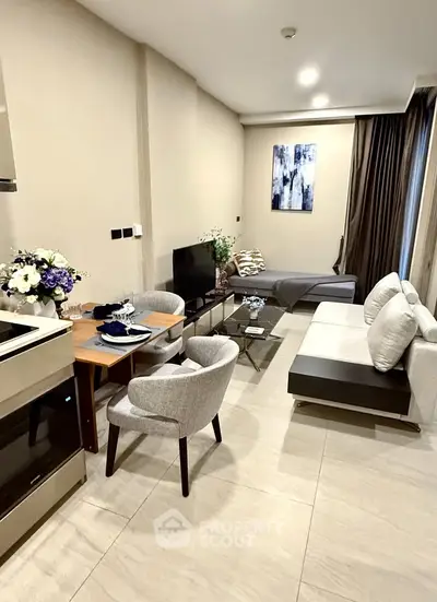 Modern living room with stylish decor and open layout, featuring a cozy seating area and elegant dining space.