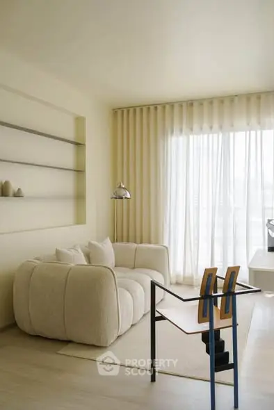 Modern living room with stylish furniture and large window for natural light.