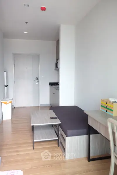 Modern minimalist bedroom with sleek design and wooden flooring, perfect for urban living.