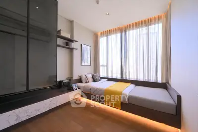 Modern bedroom with sleek design and large windows for natural light