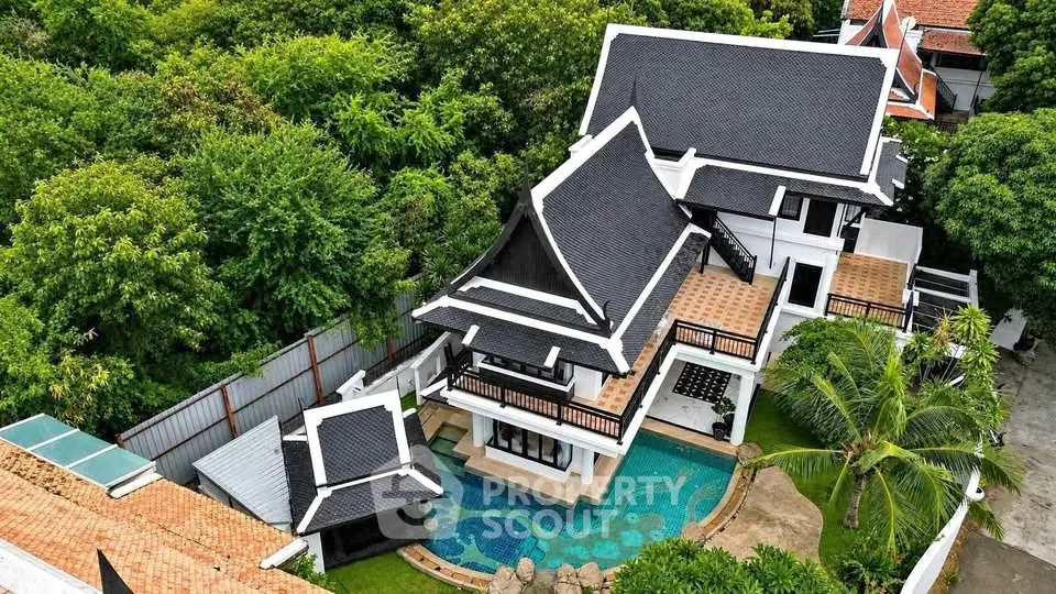 Stunning aerial view of luxurious Thai-style villa with private pool and lush greenery.