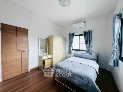 Cozy bedroom with modern furnishings and natural light