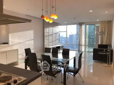 Modern open-plan living and dining area with city view and stylish lighting.