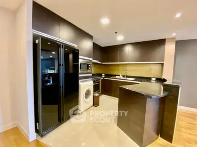 Modern kitchen with sleek black appliances and open layout