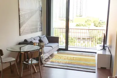 Modern living room with large window and balcony view in urban apartment
