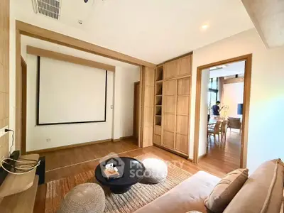 Spacious living room with modern decor and built-in shelving, perfect for relaxation and entertainment.