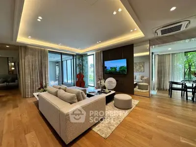 Luxurious living room with modern decor and large windows offering scenic views.