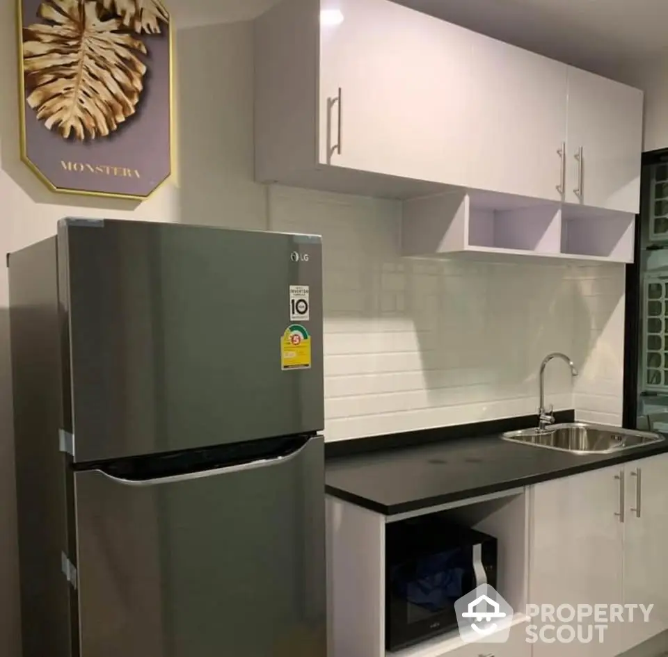 Modern kitchen with sleek cabinets and stainless steel fridge